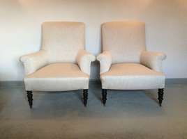 A pair of French upholstered armchairs